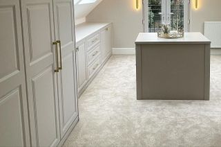 Grey carpet with pink sofa and blue walls